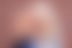 Young woman raising her hand in a calm stop gesture, symbolizing healthy personal boundaries and emotional self-care.