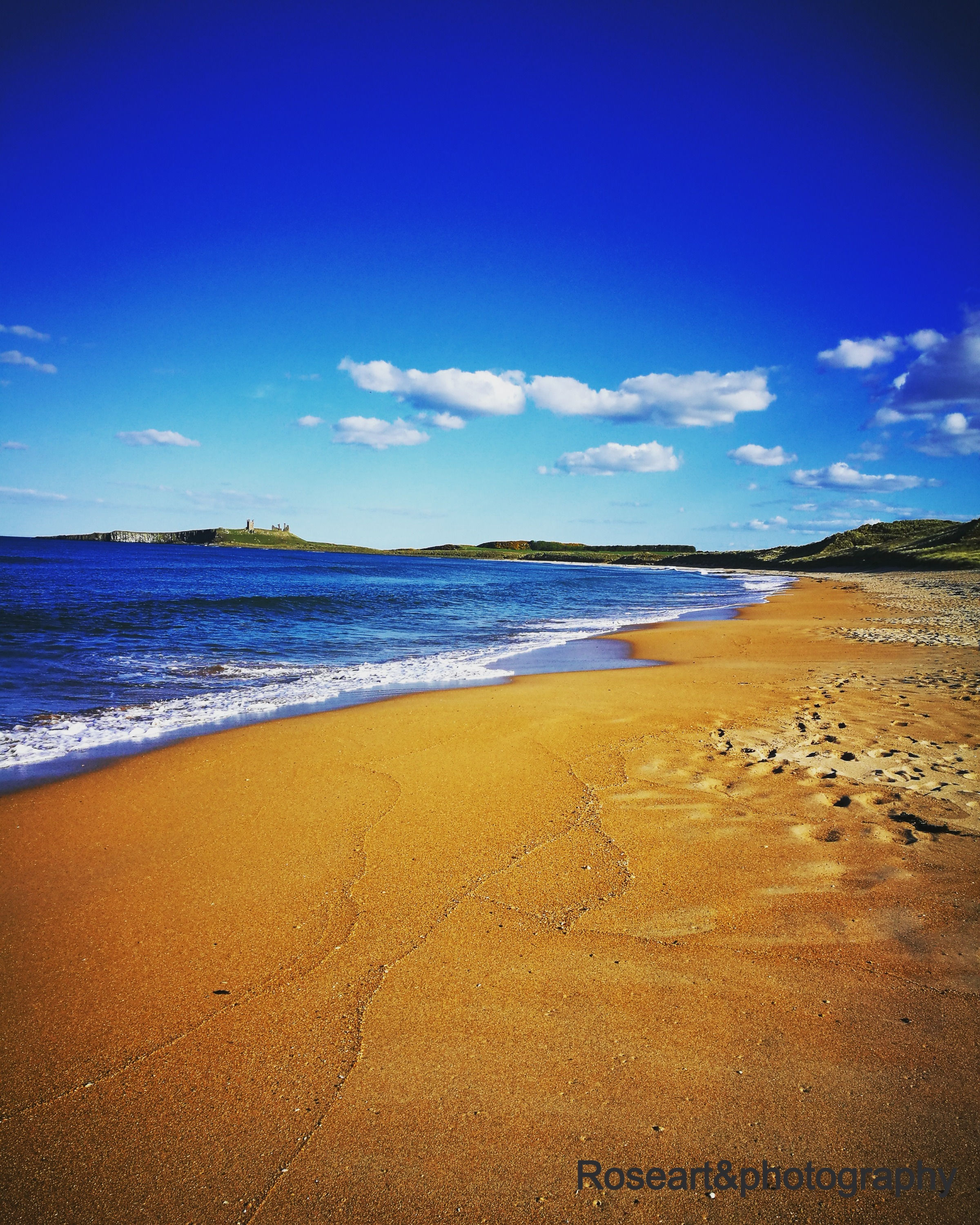 Sandy Shores, view of Dunstanburgh Castle, vivid colours, landscape photography, beach and sea scenery, stunning prints