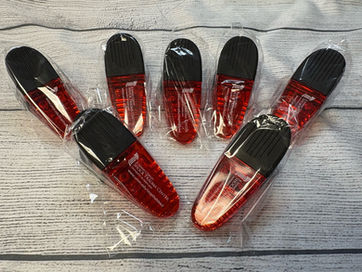 A small, magnetic plastic clip (chip clip) customized with a full-color circular logo.