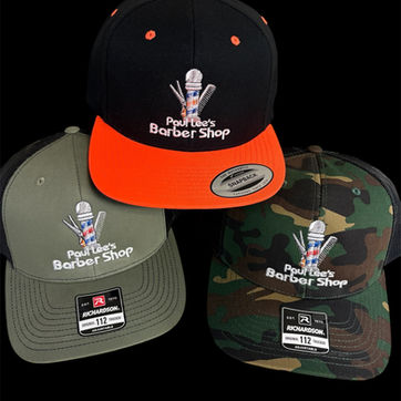Three custom embroidered baseball caps for a "Barber Shop" logo, including a black/orange flat-bill, an olive green snapback, and a camouflage option.