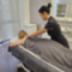 Deep tissue massage targeting back and shoulders during rehabilitation session