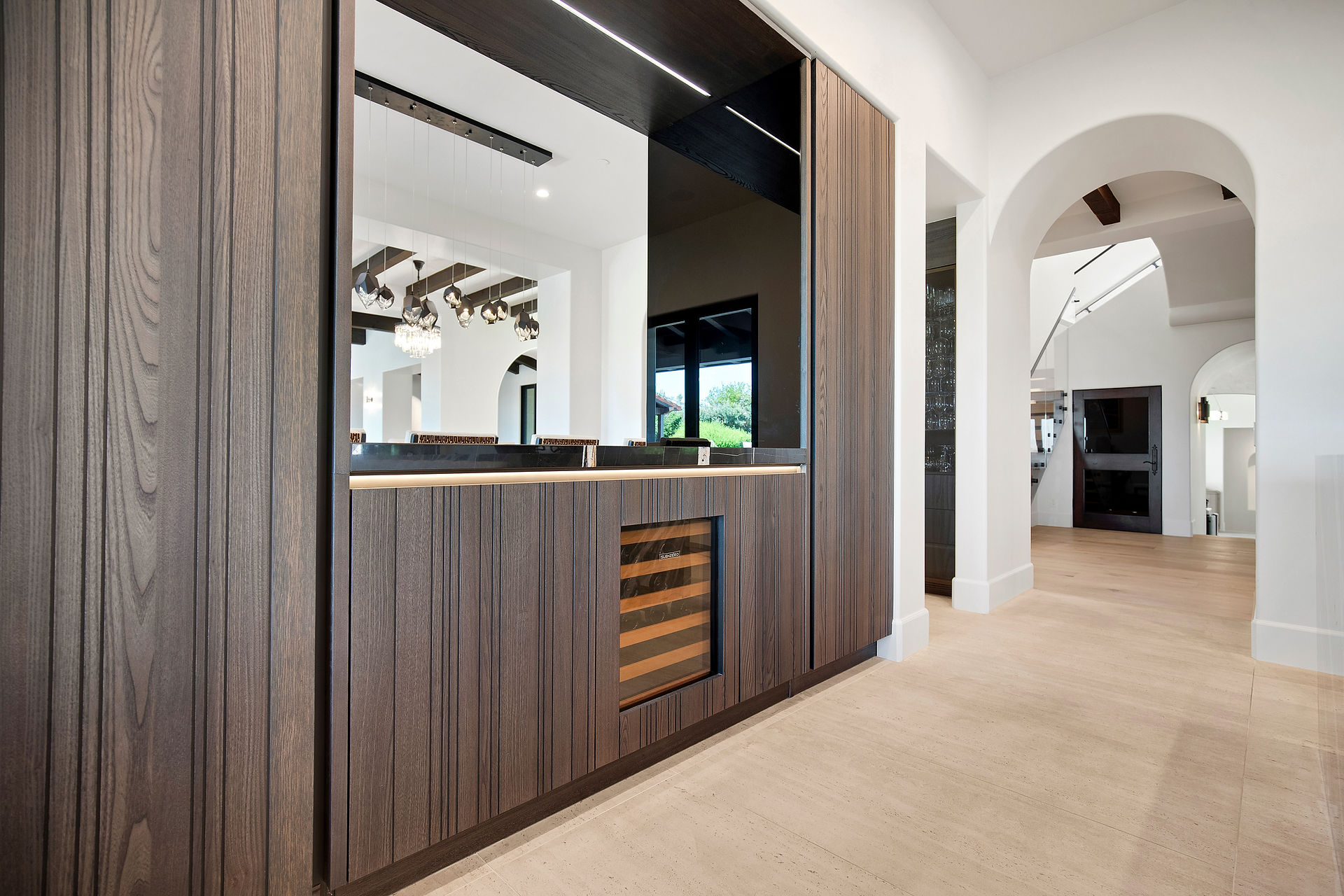 Contemporary wine bar opening the kitchen to the dining space.