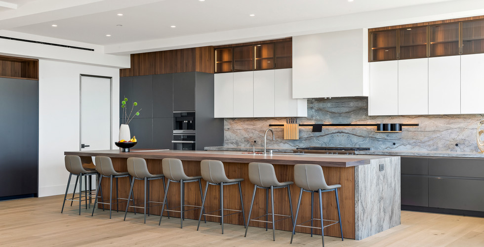 Contemporary kitchen featuring handleless cabinetry and integrated appliances.