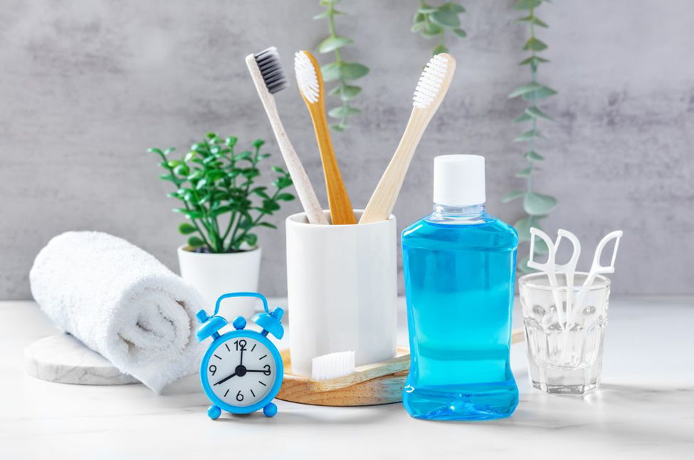 Bathroom essentials, toothbrushes, mouthwash, floss, towel & alarm clock