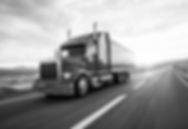 diesel semi truck driving down the road