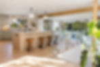Modern open-concept kitchen design showcases meticulous attention to detail, featuring high-end materials such as marble countertops, wooden accents, and sleek cabinetry, highlighting the importance of considering both finish materials and labor in construction costs.