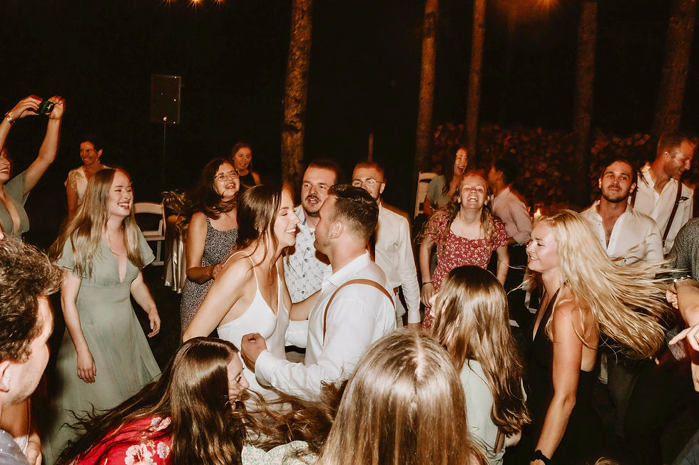 A first dance wedding couple surrounded by friends