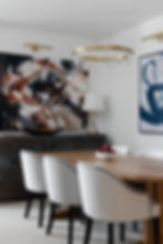 Classic contemporary dining room designed by Porch Light Interiors in Brisbane featuring, rustic sideboard, brass lamp, brass bowl, brass pendant, abstract art, oak dining table