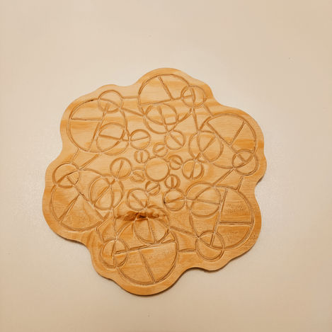 a wooden cutting board with a circular pattern on it