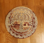 a wooden plaque with a celtic tree design on it