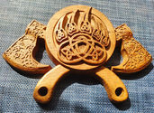 a wooden carving of a bear claw with a celtic design