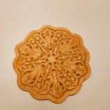 a wooden plate with a circular design on it