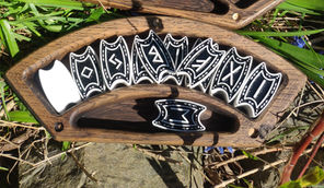 a wooden tray with black and white symbols on it