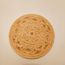 a round piece of wood with a circular design on it