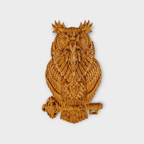 Detailed birch wood carving of owl holding key perched on branch wall art