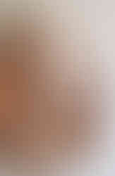 a wooden spiral calendar is hanging on a wall .