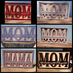 a wooden sign that says mom in different colors
