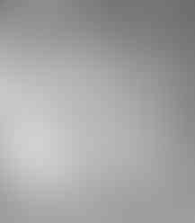 two black and white drawings of a woman 's face are sitting on a bed .