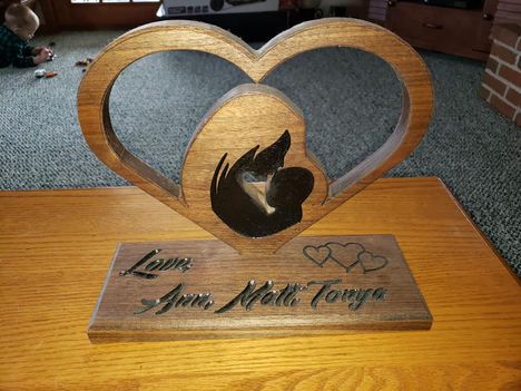 a wooden heart shaped plaque that says love ann matt tonya