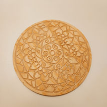 a wooden plate with a circular design on it