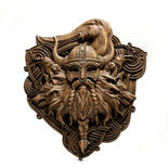 a wood carving of a viking with horns and a horse