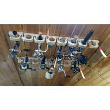 a bunch of fishing rods are hanging from the ceiling