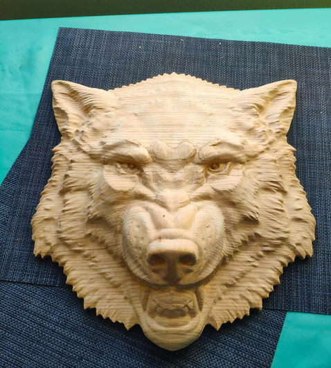 a carving of a wolf 's head on a blue cloth