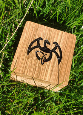 a wooden block with a black dragon on it