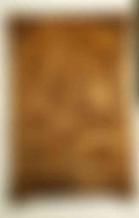 a wood carving of a man sitting on a throne with two wolves