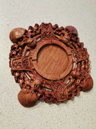 a wooden carving with skulls and bones on it
