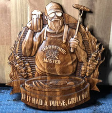 a wood carving of a man that says barbeque master