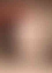 a framed drawing of a woman 's back is sitting next to a vase of leaves .