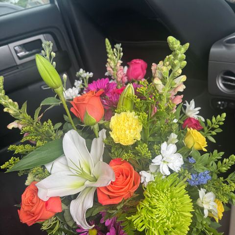 Bright mixed flower arrangement with lilies and roses