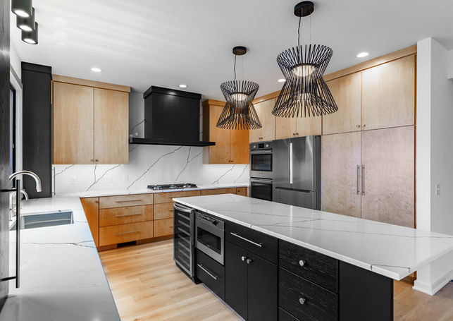 Custom kitchen cabinets.
Birdseye maple with natural finish, and hickory painted black. 
Slab doors and drawer fronts, flat crown, full overlay style.