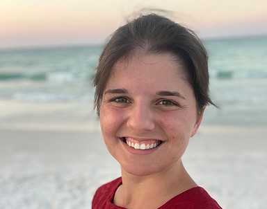 Smiling woman on beach at sunset
