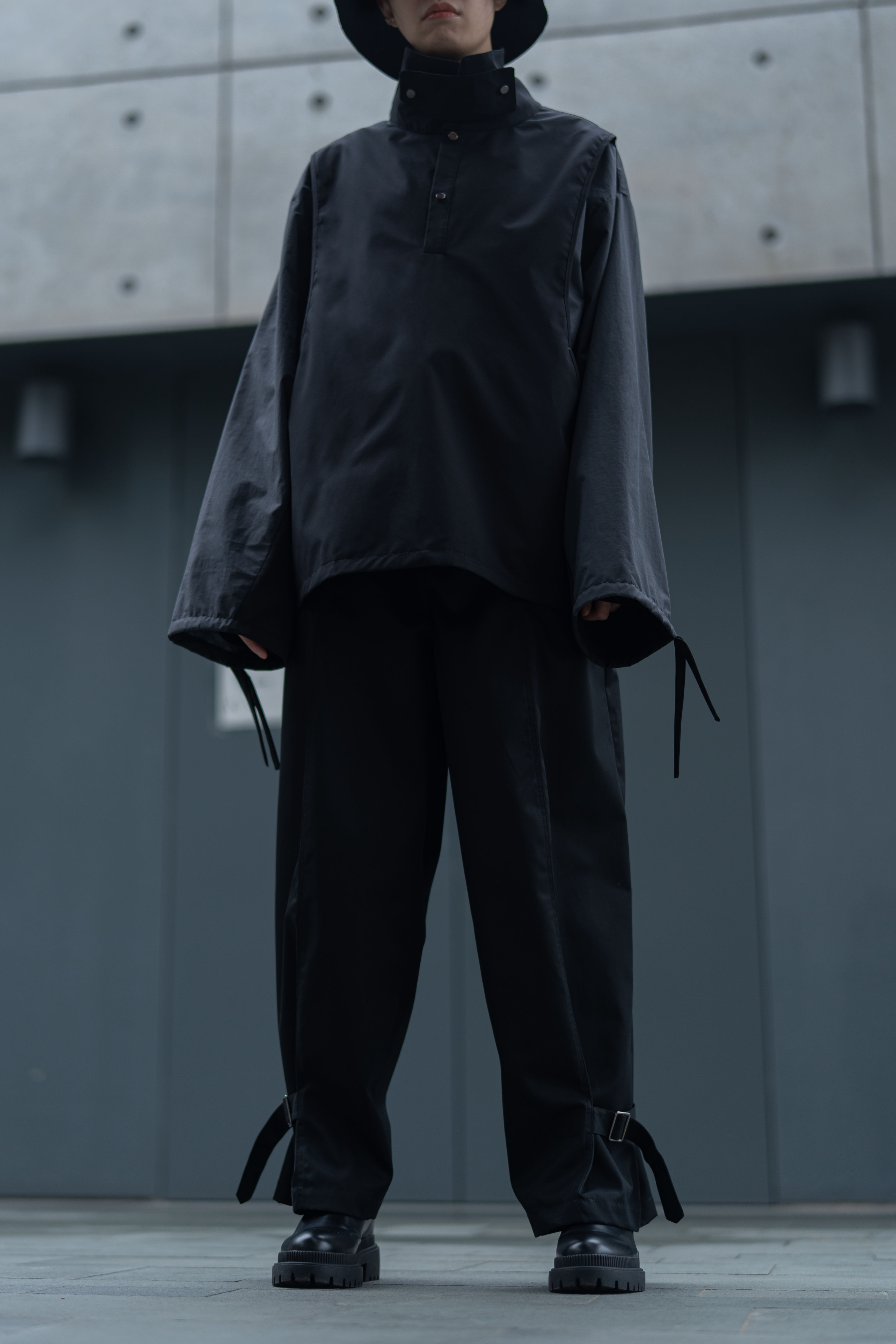 black split-buckled pants