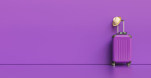 Suitcase with hat and sunglasses on purple background. travel concept, with copy space for