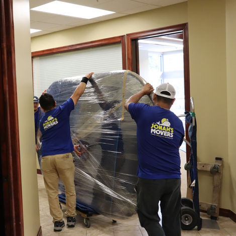 Picture of movers Carrying a heavy Table