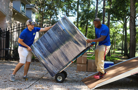 Picture of Dollying a Dresser up the truck ramp in The Woodlands Texas