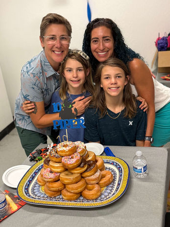 Family celebrating a child's birthday with donuts at Ninja Republic ninja warrior gym in San Mateo, CA