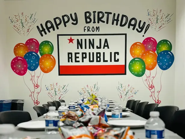 Birthday party table setup at Ninja Republic in San Mateo, CA with colorful balloons and Happy Birthday banner