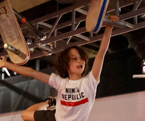 Child swinging through ninja course challenge at Ninja Republic in San Mateo, CA