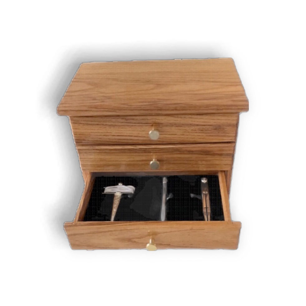 Thumbnail: Wooden cabinet with three drawers with open bottom drawer.