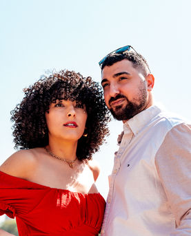 Couple posing outdoors with a red dress and white shirt. couple photography Chicago
