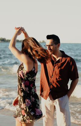 Couple dancing on the beach, couple photography Chicago, near the ocean waves.