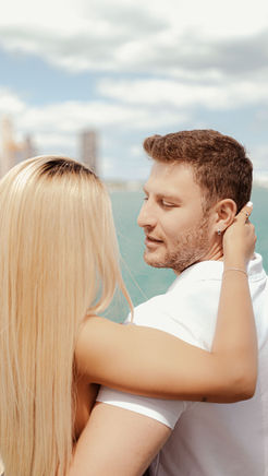 Couple embracing outdoors, blue sky, water, couple photography Chicago, Monograin.