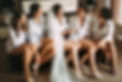 Bride laughing with bridesmaids