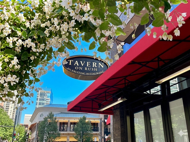 Tavern on Rush restaurant exterior in Chicago's gold coast with spring flowers blooming in the overhead baskets.
