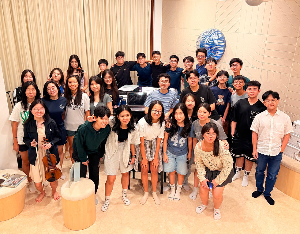 The singers of D'Jam pose for a photo with Ron around the grand piano all-smiles