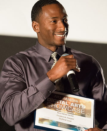 Award winning creative artist, Fredrick Harper, accepts an award for "best male actor" from American Intercontinental University.